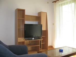 a living room with a flat screen tv on a shelf at Apartments Pende 3122 in Banjol