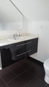a bathroom with a sink and a toilet at Apartamentos Corcubión in Corcubión +35 photos