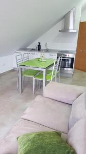 a kitchen with a table and chairs in a room at Apartamentos Corcubión in Corcubión