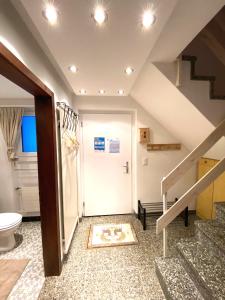 a bathroom with a staircase and a white door at Haus Trynsch Flumserberg in Flumserberg