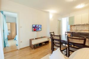 a living room with a kitchen and a dining room at Apartments Leut 80m from the Sea in Podgora