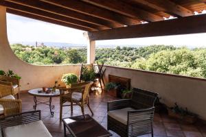 un patio con sillas, mesa y chimenea en La Vallata B&B in Sardegna en Ghilarza
