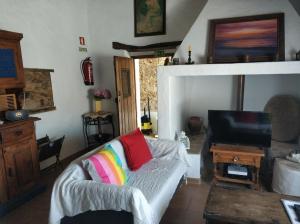 a living room with a couch and a tv at Casa da Tia Maria By Alojamentos Vitinho in São Luis