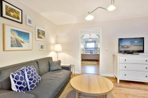 a living room with a couch and a table at Apartmenthaus Tribseer Damm 6 in Stralsund