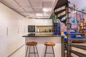 a kitchen with a counter and two stools at Retro Apartment Old Town in Wrocław
