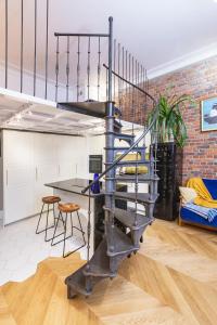 a metal spiral staircase in a room with a brick wall at Retro Apartment Old Town in Wrocław