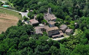 an aerial view of a large house in the forest at Castello di Montalto in Castelnuovo Berardenga