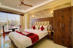 a bedroom with a large bed and a large window at Hotel Samaira Residency,Dombivali in Dive