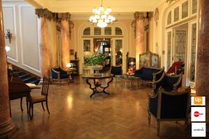a living room filled with furniture and a large window at Grand Boutique Hotel in Bucharest