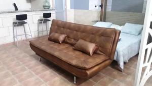 a brown leather couch sitting in a living room at INDUSTRIAL LOFT in Guargacho