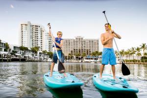 a man and a boy are paddling a kayak in the water at Hyatt Regency Sarasota in Sarasota