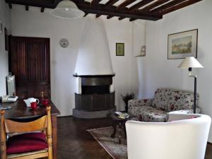 a living room with a couch and a fireplace at Castello di Montalto in Castelnuovo Berardenga