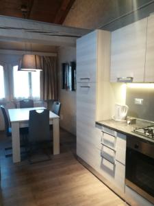 a kitchen with a table and a dining room at Hotel Centrale in Bologna