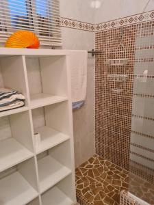 a bathroom with white shelves and a shower at pardelo in Adeje +16 photos