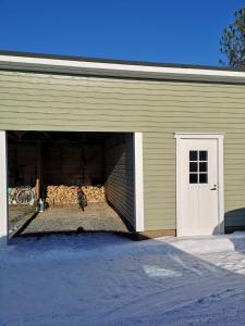 a garage with a person standing inside of it at SARA - Modern Row Aprt with Sauna - 24h Check-in in Närpiö +3 photos