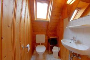 a bathroom with a toilet and a sink at Strandvogt 2 TR8 in Dorum Neufeld