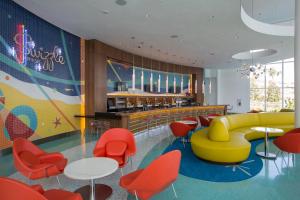 a waiting room with colorful chairs and tables at Universal's Cabana Bay Beach Resort in Orlando