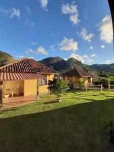 a view of a house with mountains in the background at Chalés da Serra in São Pedro da Serra