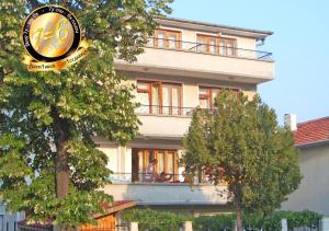 a building with a clock in front of it at Pension Dicev in Obzor +28 photos