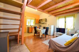 a room with a bed and a table and a kitchen at Apartments Duje Zadar in Zadar