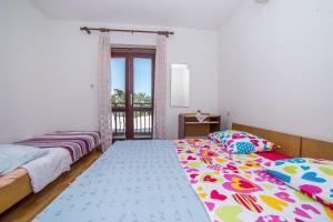 Ένα ή περισσότερα κρεβάτια σε δωμάτιο στο Apartments and Rooms Drpić +21 φωτογραφίες