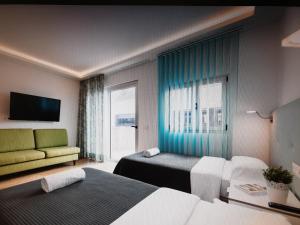 a hotel room with two beds and a window at Atlantic Apartments in Las Palmas de Gran Canaria