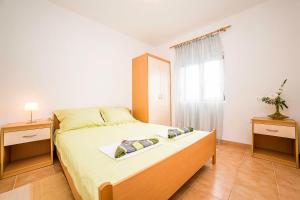 Postel nebo postele na pokoji v ubytování Apartments Bakula 1539