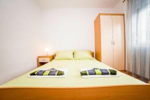Postel nebo postele na pokoji v ubytování Apartments Bakula 1539