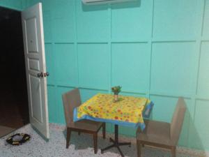 a table in a room with a table and chairs at บ้านพักกลางนา in Amphoe Sawang Daen Din