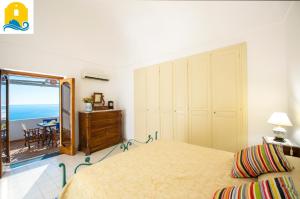 a bedroom with a bed and a view of the ocean at Casa Elisabetta in Praiano