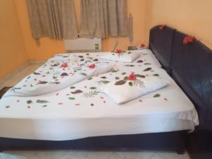 a bed with floral sheets and pillows on it at New Panorama Resort in Fayoum