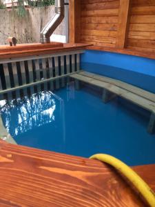 a swimming pool in a house with a water fountain at Mató Vendégház in Bogács