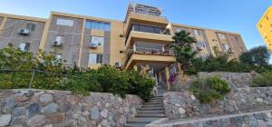a building with stairs and a stone wall at Yuval holidey aprtment eilat in Eilat