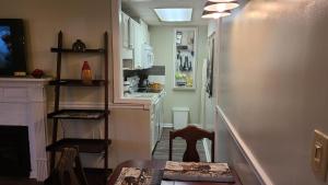 a kitchen with a table and a kitchen with white cabinets at Gatlinburg Chateau Condo 506 in Gatlinburg