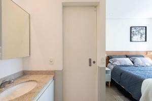 a bathroom with a sink and a bed in a room at Tag Decor in Sao Paulo +14 photos