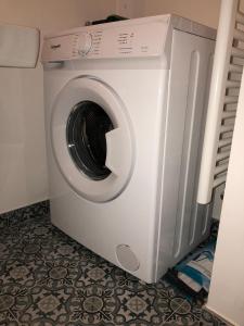a white washing machine sitting in a room at Flair and Design Apartment! in Vienna