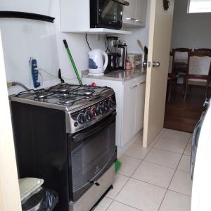 a kitchen with a stove top oven in a kitchen at Greyhouse in Puerto Natales