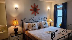 a bedroom with a bed with a flower clock on the wall at Gatlinburg Chateau Condo 506 in Gatlinburg +18 photos