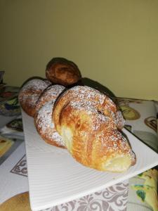 a plate with several breads on a table at Le Coste Affittacamere in San Lupo