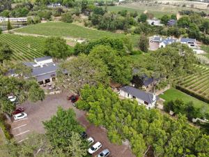 an aerial view of a house with a parking lot and trees at Le Pommier Country Lodge in Stellenbosch
