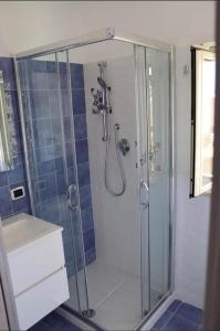 a bathroom with a shower and a sink at Samuel Fish in Bagnara Calabra