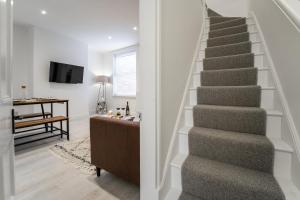 a staircase in a home with a living room at South View - 3 bed modern Chester house - Close to city centre in Chester