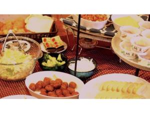 a table with plates of food on a table at Self inn Tokushima kuramoto ekimae - Vacation STAY 19498v in Tokushima