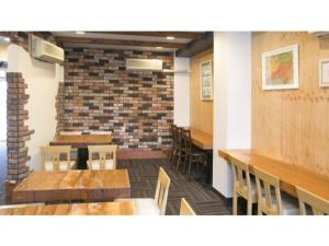 a room with tables and chairs and a brick wall at Self inn Tokushima kuramoto ekimae - Vacation STAY 19485v in Tokushima