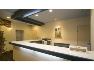 an empty office with a white counter in a room at Self inn Tokushima kuramoto ekimae - Vacation STAY 19485v in Tokushima