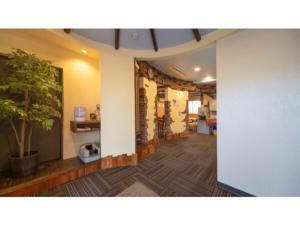 a room with a hallway with a potted tree in it at Self inn Tokushima kuramoto ekimae - Vacation STAY 19485v in Tokushima