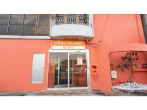 an orange building with a sign in front of a door at Self inn Tokushima kuramoto ekimae - Vacation STAY 19485v in Tokushima