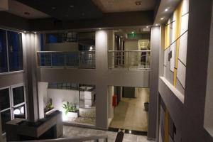 an overhead view of an apartment building with a hallway at Leguizamon Studios & Suites Premium in Salta