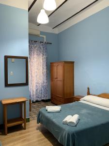 a bedroom with a bed with two towels on it at Pensión Lisdos in Seville