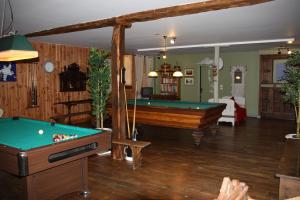 a billiard room with a pool table and a room with at Moulin de la Beraudaie in Bohal